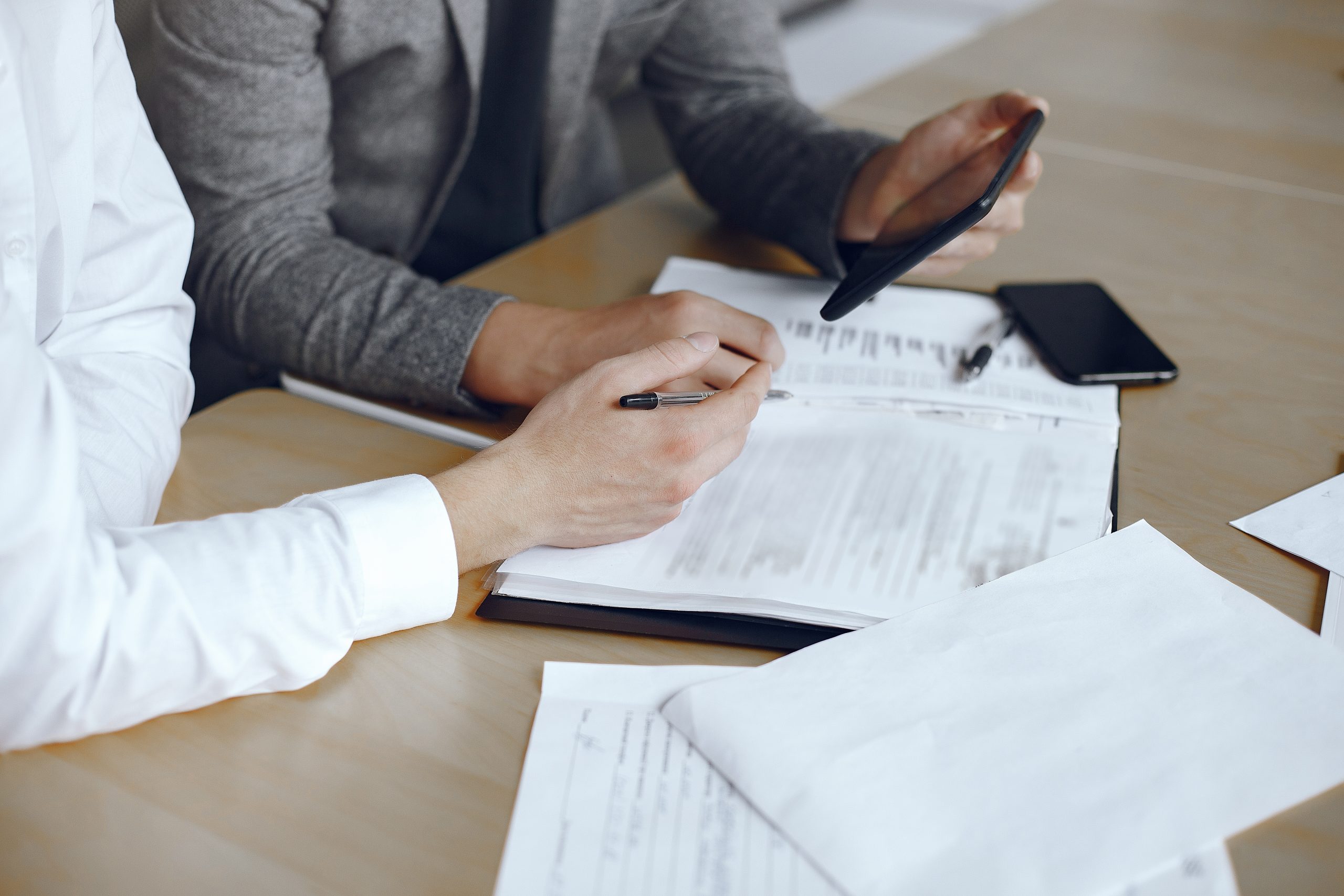 business men sitting lawyers s desk people signing important documents scaled